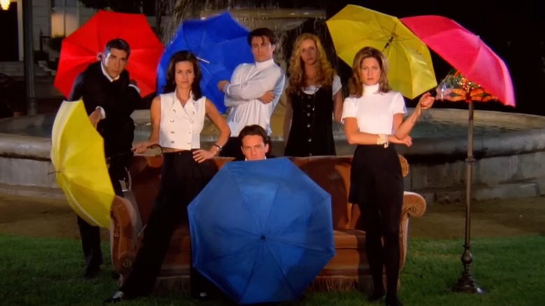 Ross, Monica, Chandler, Joey, Phoebe, and Rachel open umbrellas in the Friends show intro.