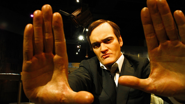 Quentin Tarantino framing his face with his hands