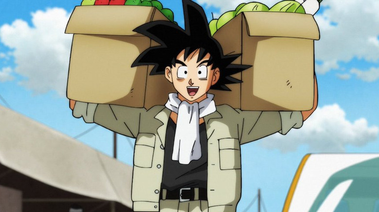 Goku in normal clothes carrying two boxes of crops