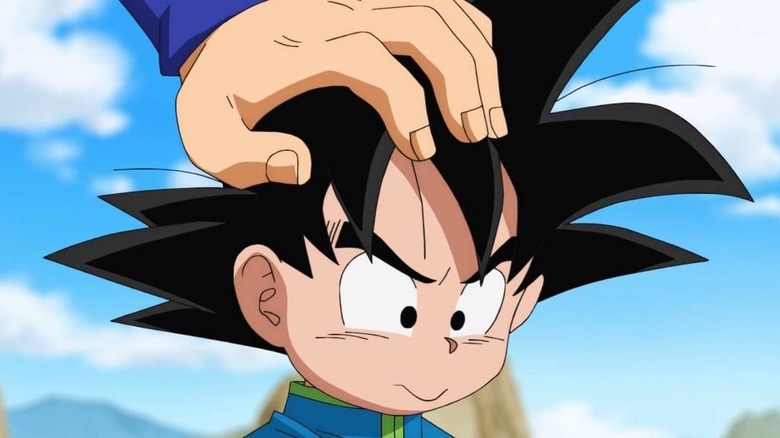 Goku's hand on frustrated Goten's head