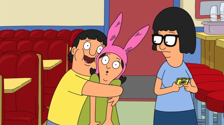 Gene squeezing Louise in front of Tina