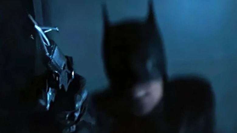 Batman shooting a grapnel gun