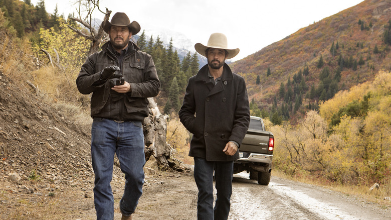 Walker and Rip walk down a dirt road