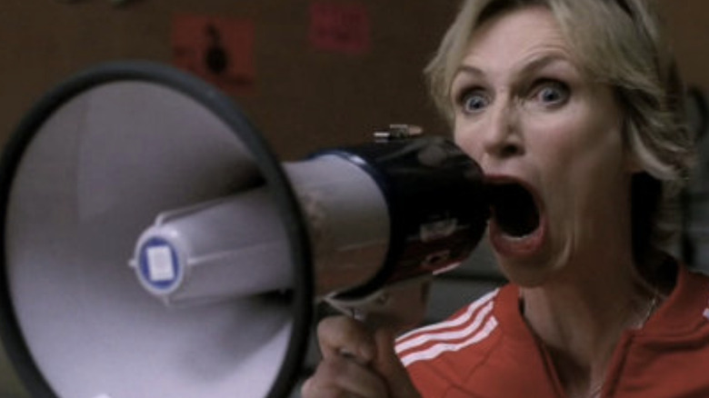 Sue screaming into a megaphone