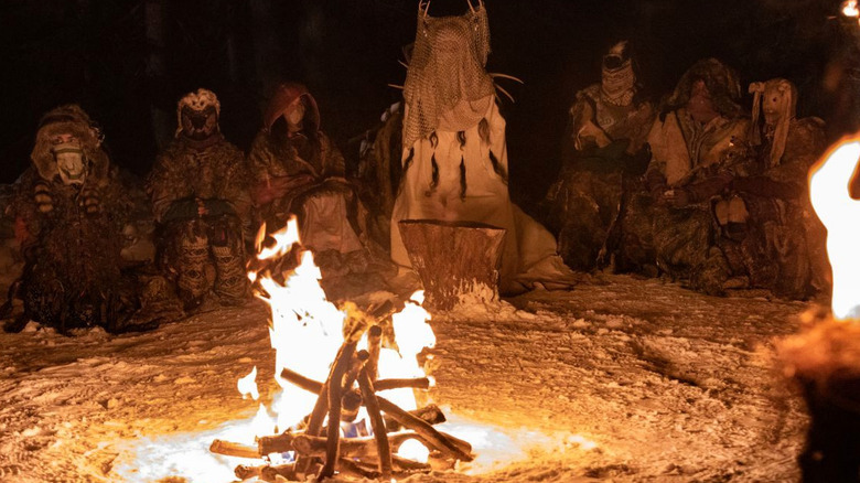 Masked people around fire in Yellowjackets