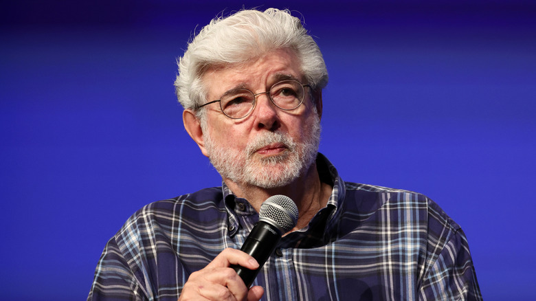 George Lucas holding microphone