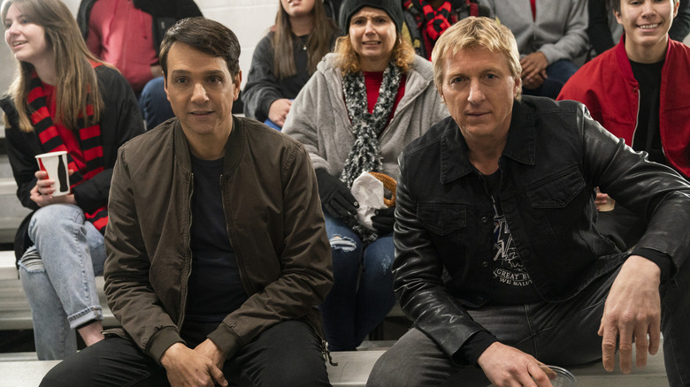 Ralph Macchio and William Zabka sitting together in Cobra Kai