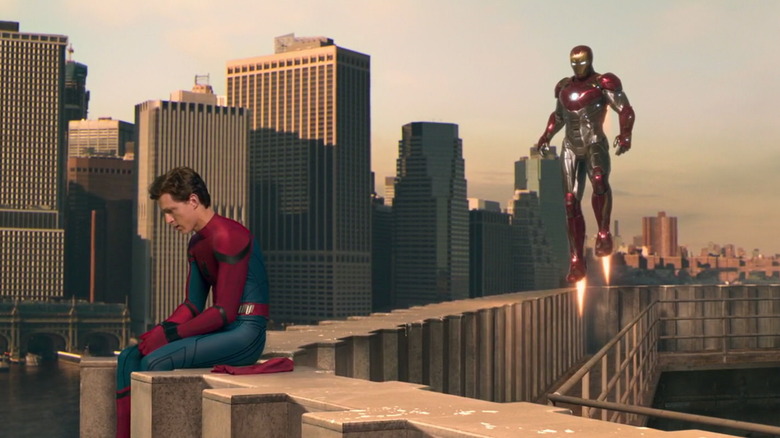 Iron Man flying by Spider-Man 