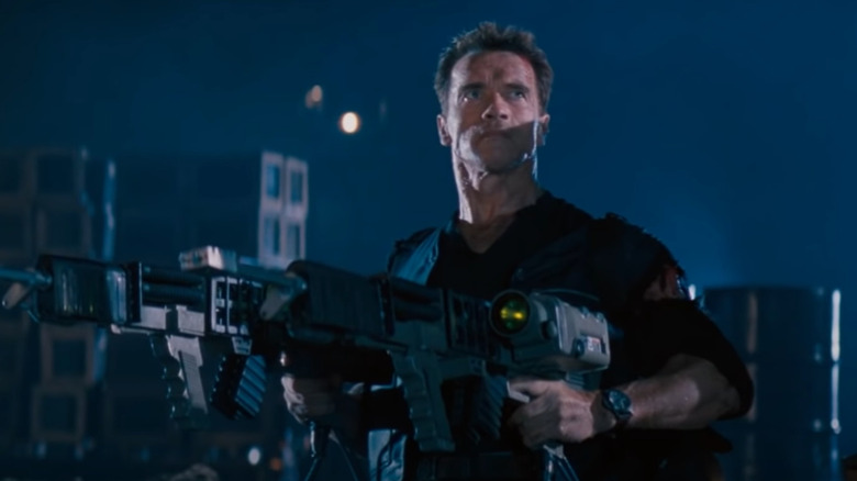 Arnold Schwarzenegger holding huge guns