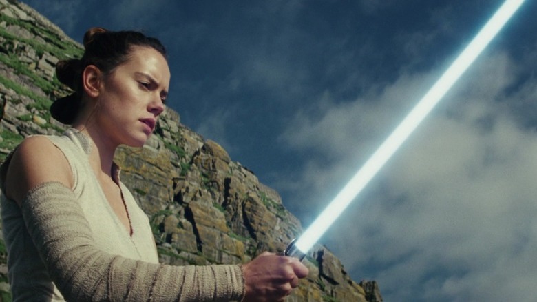 Rey with lightsaber