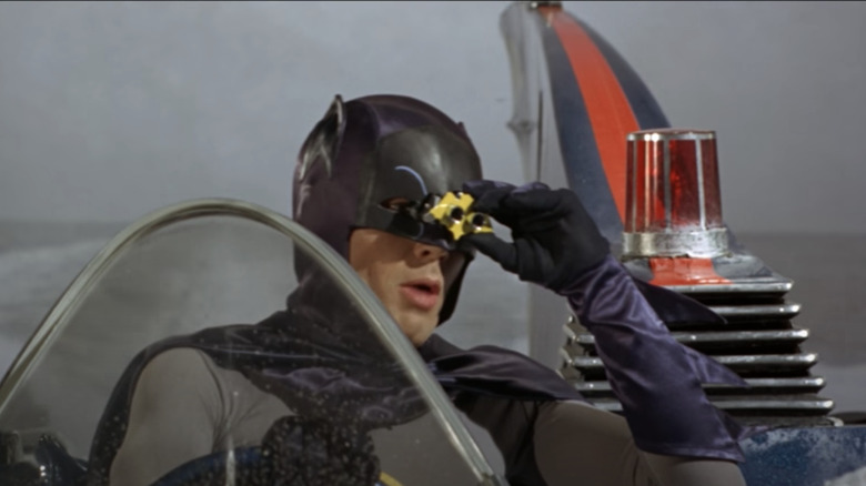 Adam West looks through bat-binocs