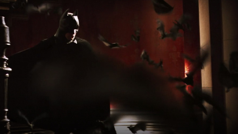 Christian Bale surrounded by bats