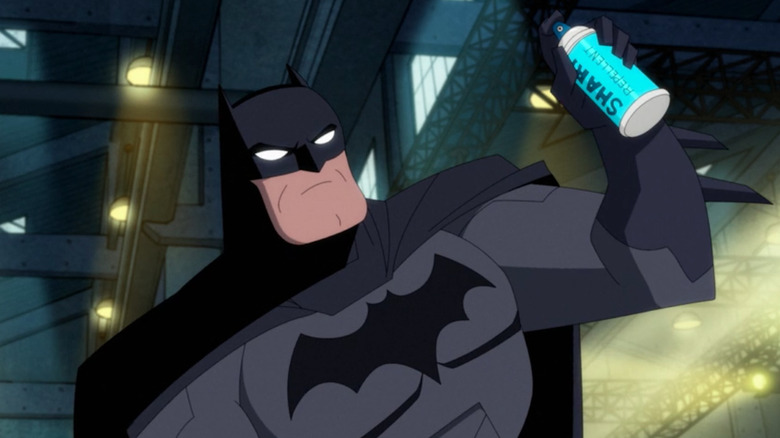 Batman holding a can of shark repellent