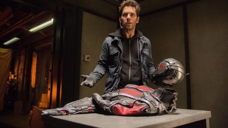 Paul Rudd standing over the Ant-Man outfit