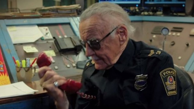 Stan Lee in a police uniform talking on the phone