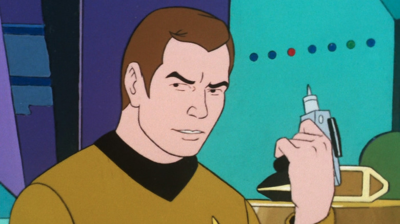 Kirk holds a phaser