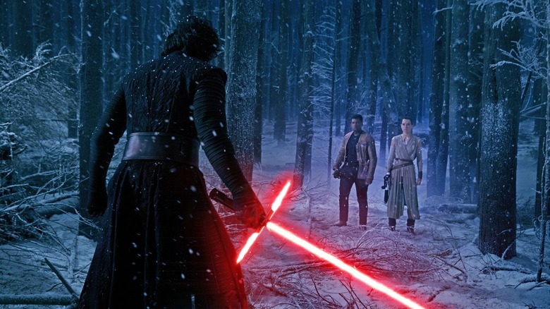 Kylo Ren facing Finn and Rey in the snow