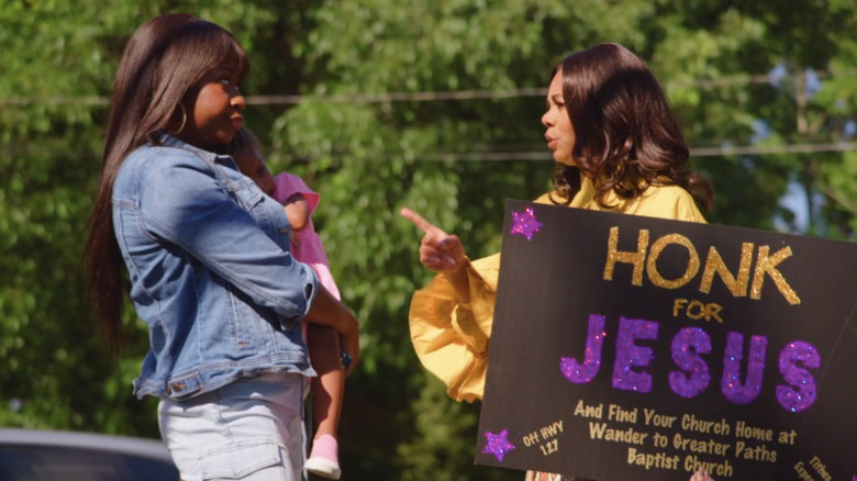 Trinitie arguing while holding sign