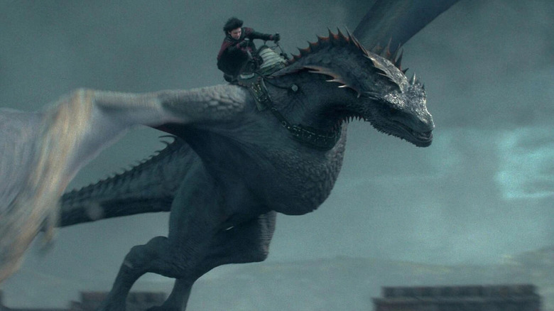 Lucerys riding Arrax through a storm sky in House of the Dragon (2022)