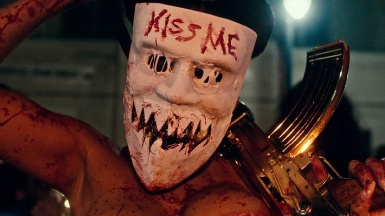 Purger wearing Kiss Me mask