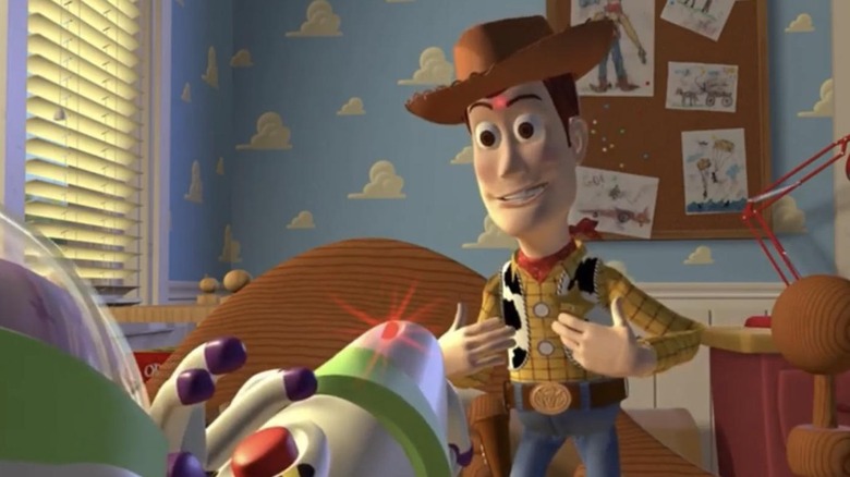 Buzz Lightyear points laser at Woody