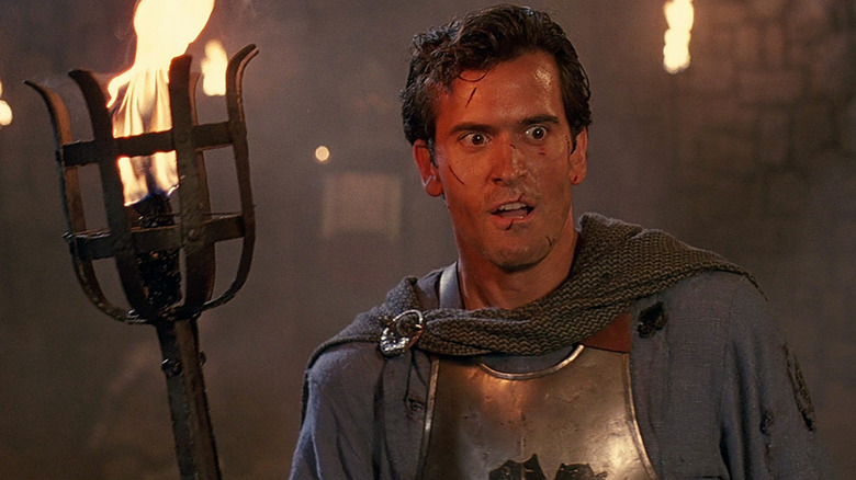 Bruce Campbell holding a torch