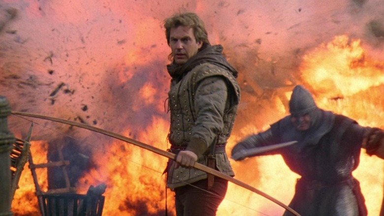 Kevin Costner holding bow and arrow