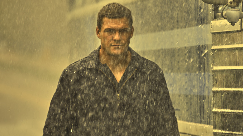 Jack Reacher wearing dark jacket in rain