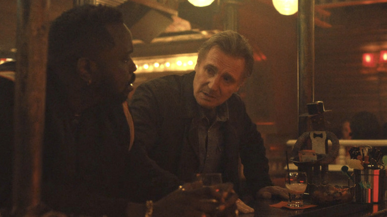 Liam Neeson talks to Brian Tyree at a bar