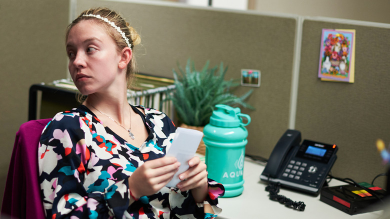 Reality sitting at her desk