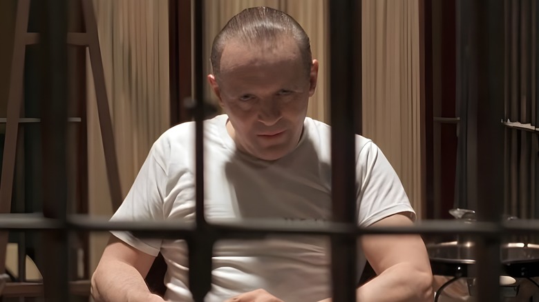 Hannibal Lecter staring through cage bars