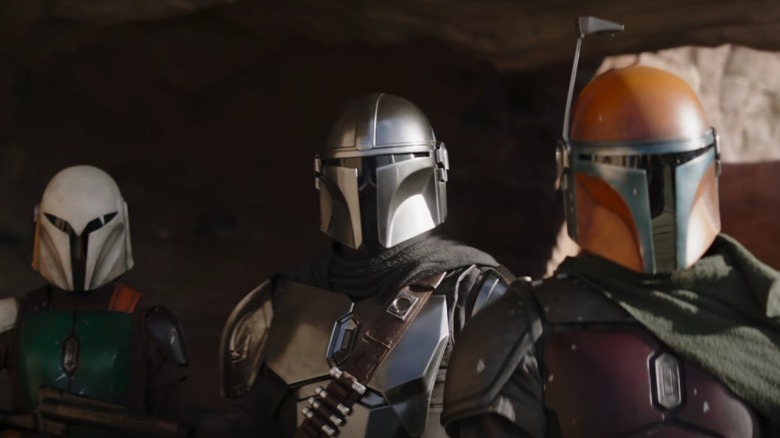 Three Mandalorians standing together