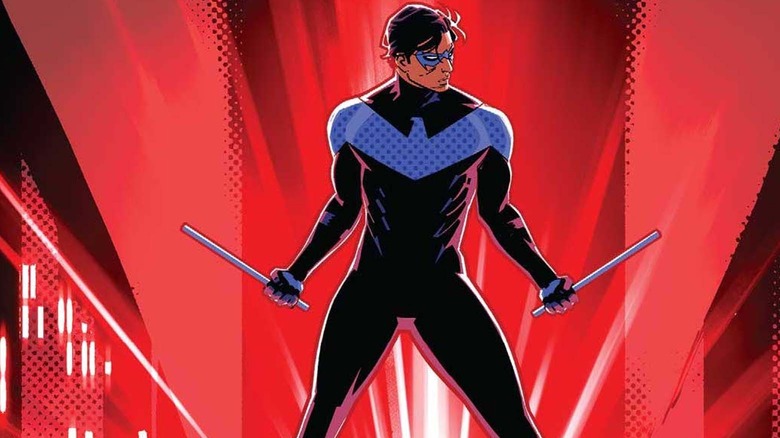 Nightwing holding his weapons striking a pose