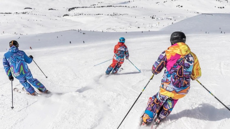 People skiing down slope