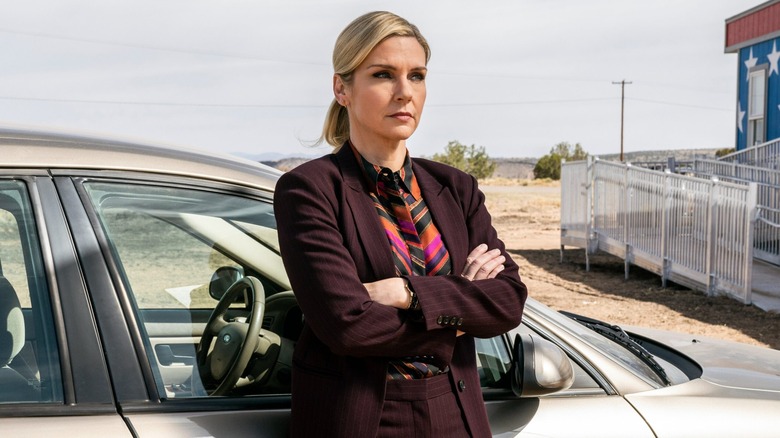 Kim Wexler stands by a car