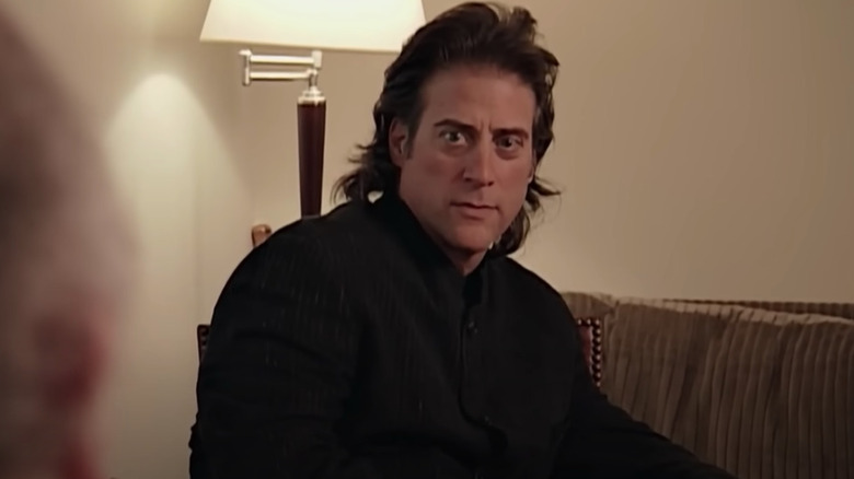 Richard Lewis sitting and staring