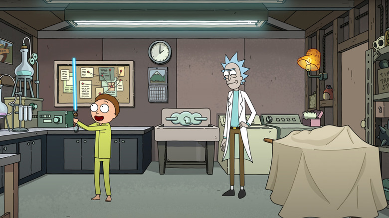 Morty wielding lightsaber as Rick watches