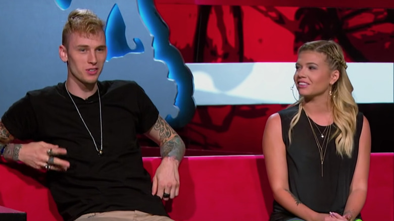 Machine Gun Kelly and Chanel West Coast sitting