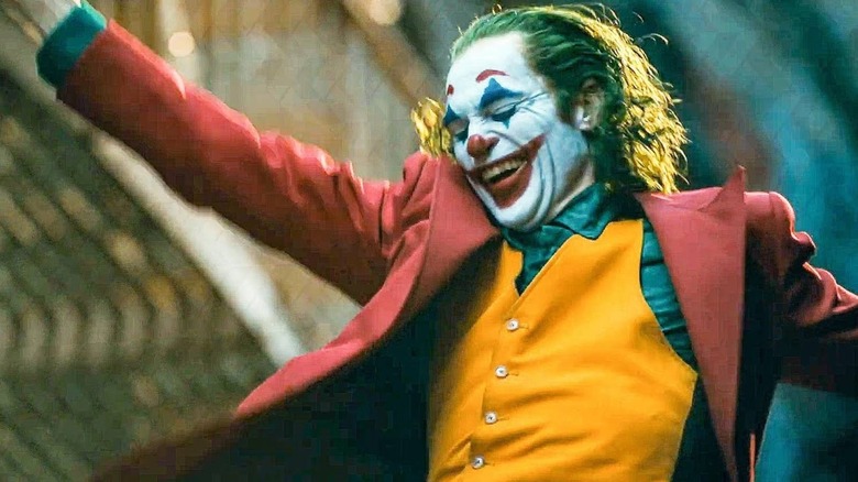 Joker dancing hands held high smiling laughing