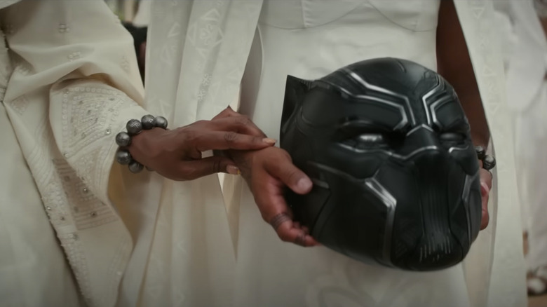 Someone holding Black Panther mask