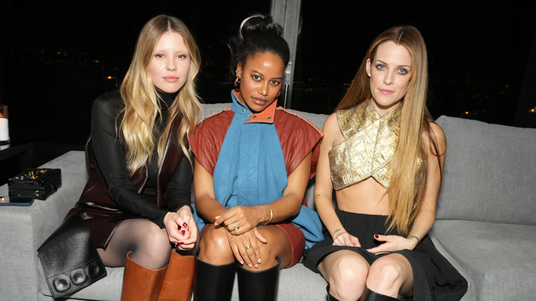 Riley Keough sitting with other models