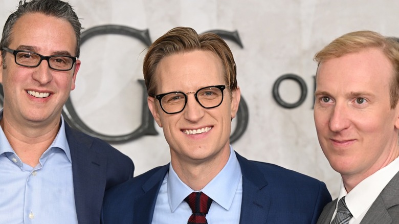 Men stand in front of white background