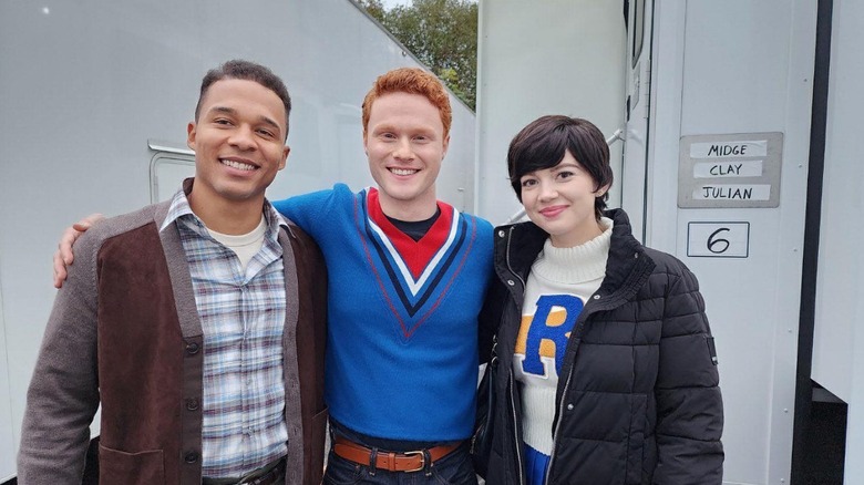 Karl Walcott, Nicholas Barusch, and Abby Ross posing on set