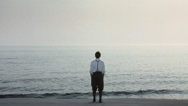 Michael Jr. standing on beach