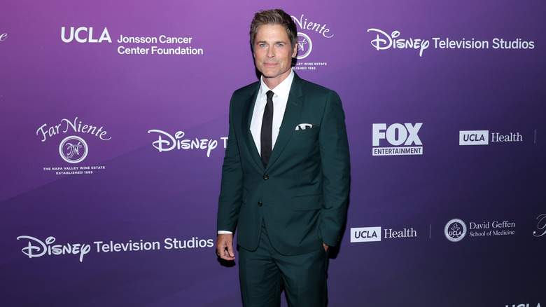 Rob Lowe standing in suit