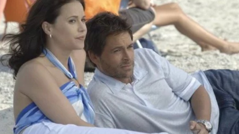 Rob Lowe and Julia Ormand lie on beach