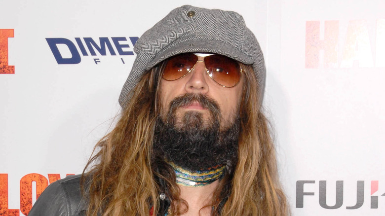 Rob Zombie wearing grey hat and orange sunglasses