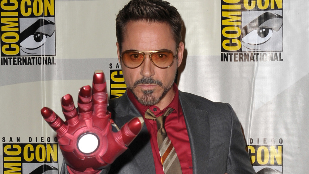 Robert Downey Jr. posing with Iron Man hand