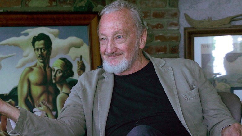 Robert Englund smiling to the left