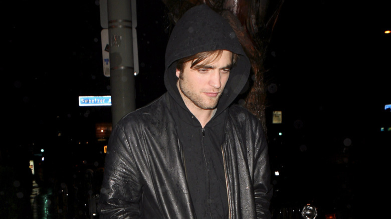 Robert Pattinson walking in hoodie